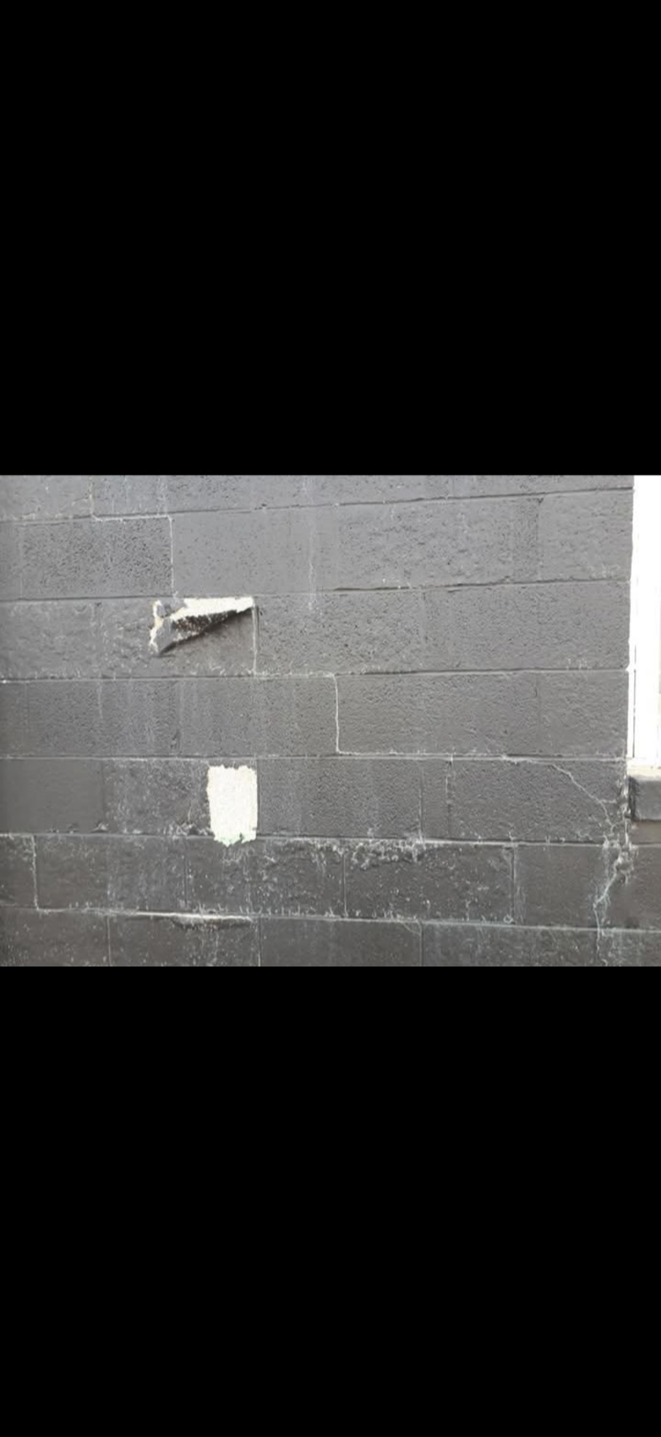 Masonry surface with areas needing preparation